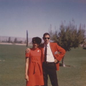 A photograph from the 1960s of a Black couple smiling happily.