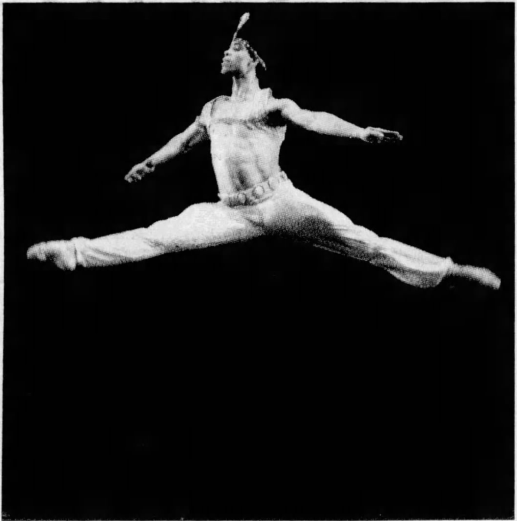 Carlos Acosta as a young man, performing in a ballet, mid-leap.
